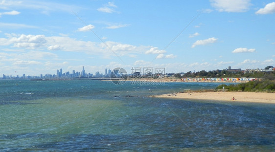 与墨尔本市天际线搭配的布赖顿海滩浴池澳大利亚城市的冲浪图片