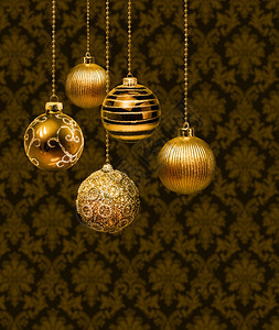 棕色的金黄圣诞球挂在达马斯克模式墙壁上银色圣诞球明亮的绫图片
