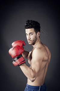 竞技20多岁冲孔成人拳击手在战斗位置的照片图片