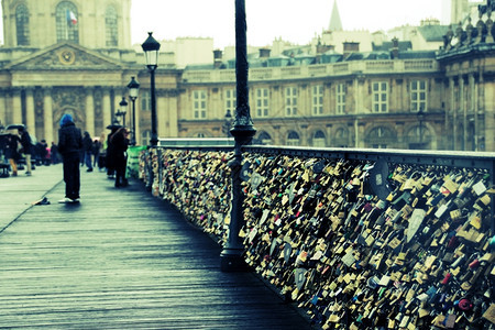 旅行游客巴黎跨越塞纳河的行人桥PontdesArts上的爱锁图片