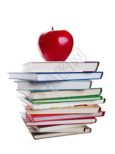 一堆书本上面有大红苹果在白色背景上拍摄照片束丰富多彩的学校图片