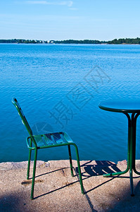 凳子在阳光明媚的一天坐在海凳上站黄边假期码头图片