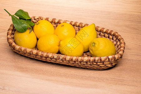 圆形的桌子一种小木篮中的黄柠檬图片