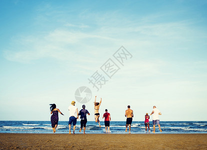 人们享受海滩开心跳跃图片