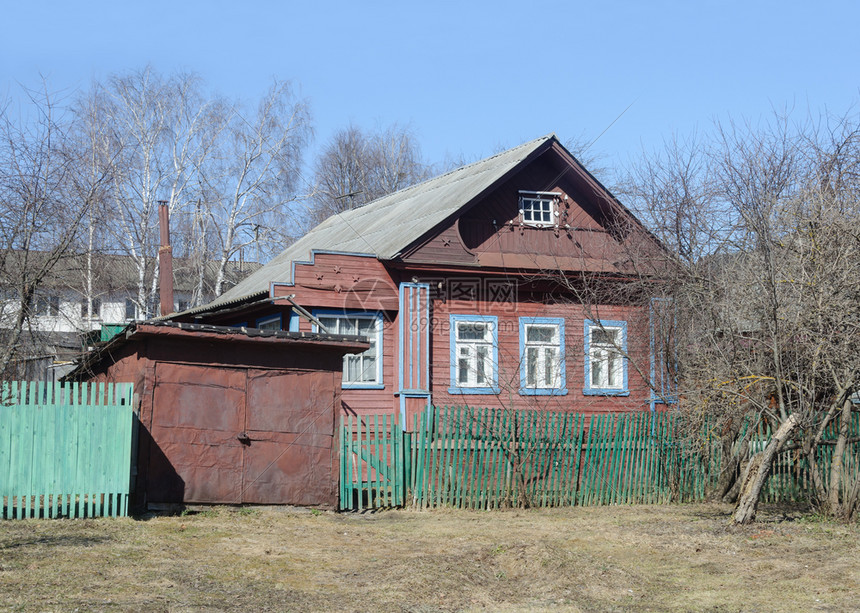 春季在俄罗斯村有车库的旧小木屋市郊春天外部的图片