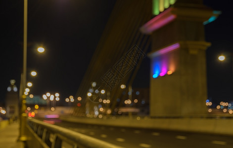 灯发光的支柱夜间与bokeh的电缆桥模糊图像图片