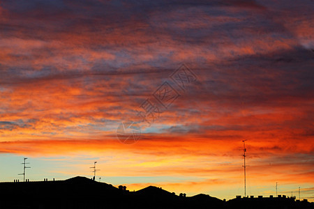 日出晚上天际线空在城市的橙色日落和云中图片
