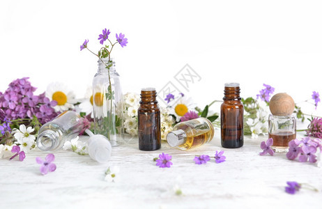 白桌上的花朵和多彩鲜香瓶关心草本新鲜图片