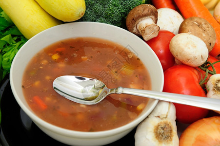 包围一种壁球蔬菜苏普碗汤匙由各种新鲜蔬菜绕过图片