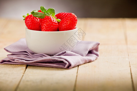 食物饮浆果木制桌子上碗里一美味草莓的照片图片