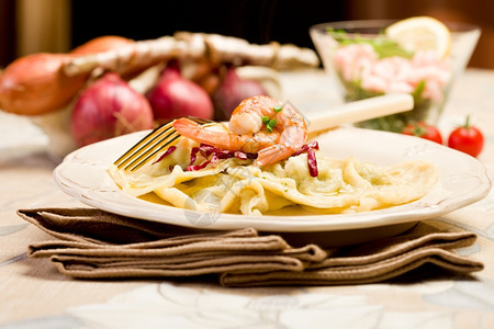餐厅地中海美味的意大利菜自制烤罗维奥兰萝卜配有虾和金叉子图片