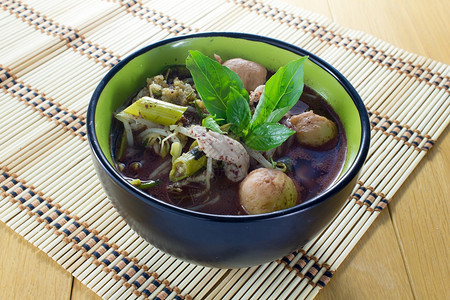 黑色的木头碗中传统塔伊食物面条牛肉图片