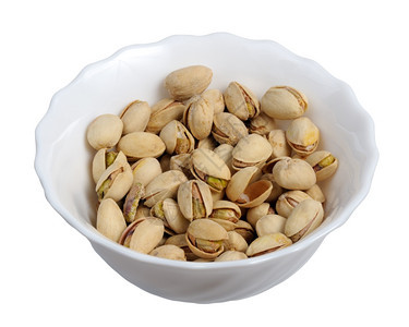 健康种子一白色背景的板上Pistachios与世隔绝图片