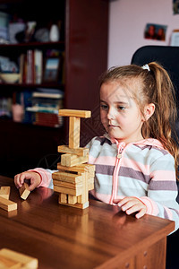 学习教育小女孩学龄前幼童玩木砖具建造一座塔构筑房子的概念有趣图片