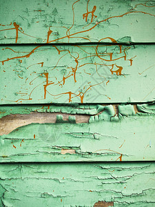 冒泡拉根华盛顿从西雅图一座腐烂建筑外墙上看到由喷泡和破碎的绿色涂料橙飞溅的颜料所创造的粗糙背景纹理图片