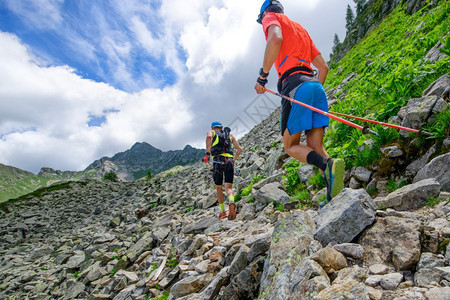 一对天际运动员在石土上攀登山丘的运动员精力充沛积极的冒险图片