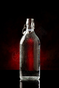 酒吧反射寒冷的黑色玻璃桌上冷水瓶和反光相片图片
