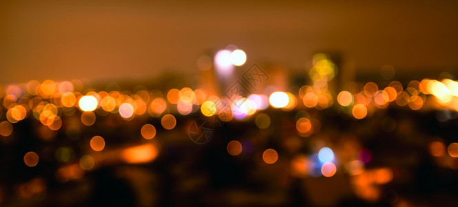 丰富多彩的抽象色无焦点的城市灯光在夜间温暖的基调橙色照明背景下产生bokoh效应模糊语气图片