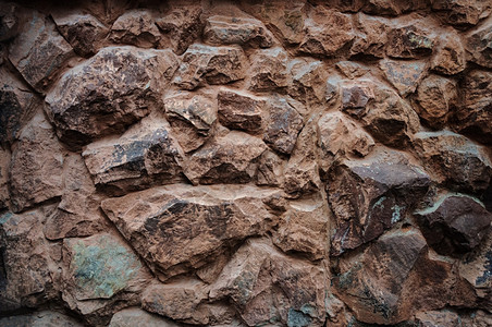 屋旧棕褐宝石墙面图案作为背景有用老的石头图片