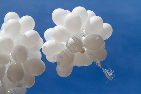 乳胶白气球对天上一堆白色气球飞向蓝天空云彩闪耀团体浪漫的图片
