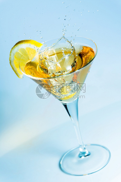 溅鸡尾酒橄榄洒在一杯马提尼上加一片柠檬食物图片