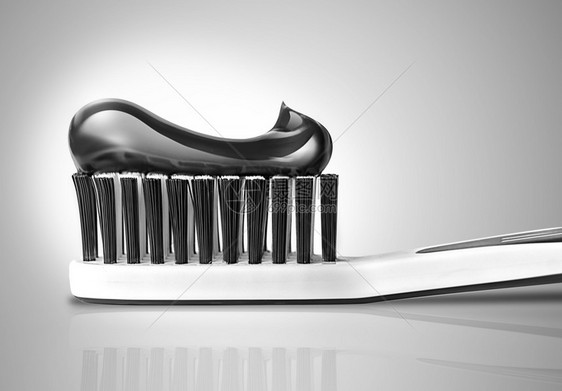 刷子涂有牙膏的刷用黑色和白3D设计口服目的图片