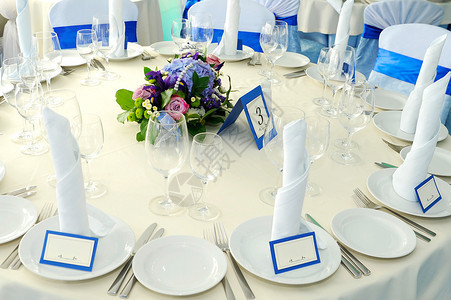 花的盘子桌布束放在宴席的餐桌上图片