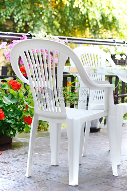 家具椅子花园露台上的白色塑料椅和桌花朵图片