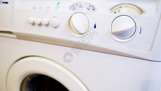 照片电子产品按钮与洗衣机控制面板的近距离拍摄图片