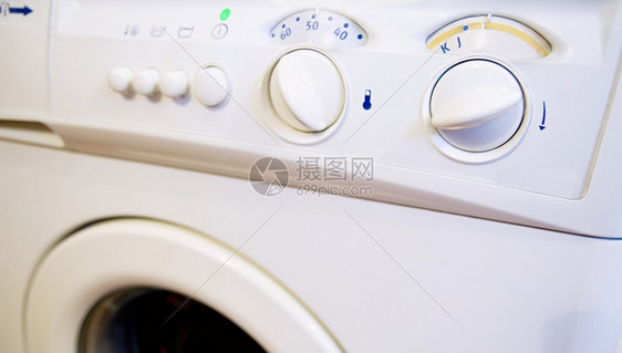 照片电子产品按钮与洗衣机控制面板的近距离拍摄图片