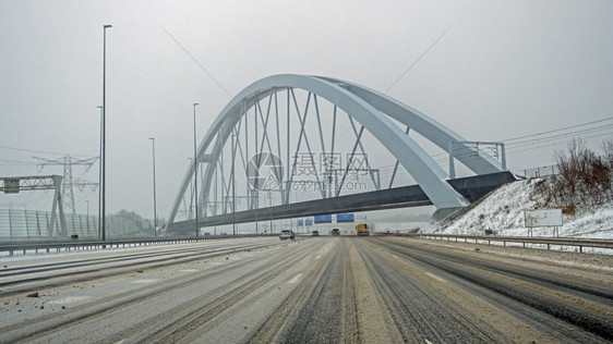 首都在阿姆斯特丹附近的A1高速公路上驾驶在荷兰暴风雪期间在Zandhazen桥的Zandhazen桥城市的交通图片