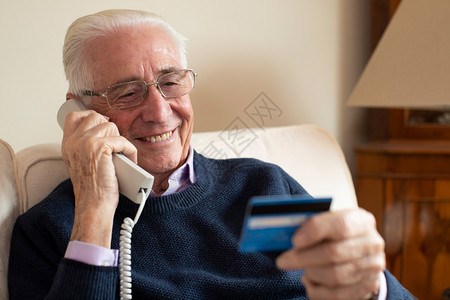 家里老年人在电话上发放信用卡详情的老人协会犯罪在室内六十年代图片