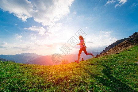 成功冒险夏季日落时女运动员在山坡草原上跑的火车夏天图片