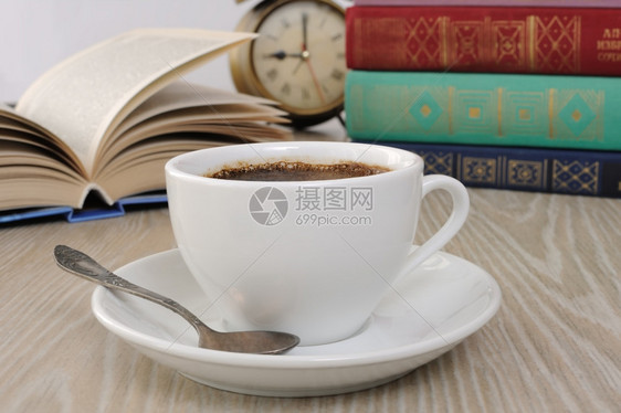 振奋人心的桌子茶上一杯香味黑咖啡背景是开放书本AxA锻炼图片