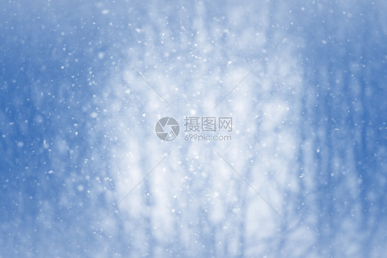 渐晕降雪冬季背景模糊雪花在运动中闪发光质地图片