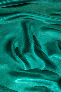 优雅的时尚波浪状绿色面纱布背景有绿的丝绸背景图片