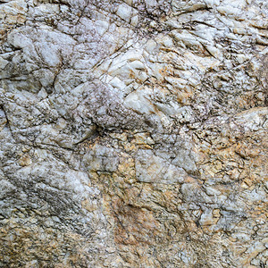 灰色的天然石头或岩背景的粗浅表面质地抽象的自然图片