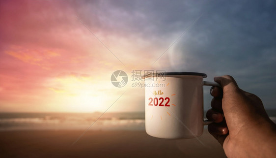 动机20年概念启动和庆祝新年在日出时海滩上喝热咖啡庆祝新年向20年的POV视图问好手茶图片