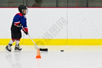 练习冰上曲棍球的小男孩图片