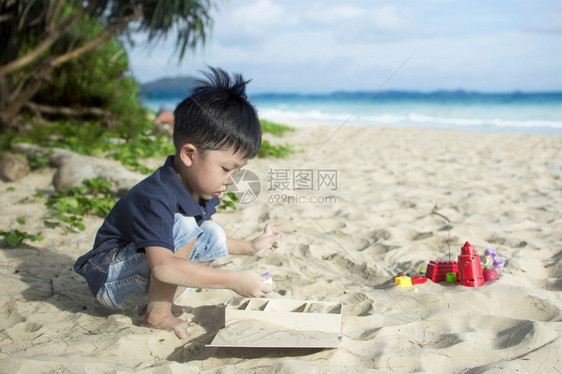 在海边沙滩玩耍的小男孩图片