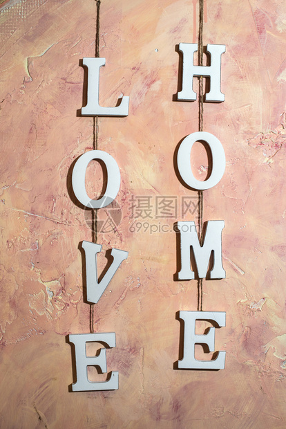 复古的爱家文字在里粉红色墙壁上白木制字符LOVE和HOME用绳子钩在墙上爱和家的概念装饰老图片