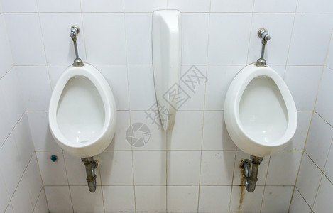 空的在公共洗手间排成一肮脏的白色小便池撒尿的图片