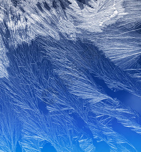 蓝色的冬天窗户上冰晶纹理和背景蓝色天空梯度上的冻结纹理窗玻璃上的季节背景Frost型样状冬季形态节背景凉爽的图片