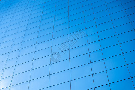 抽象的蓝色玻璃窗办公大楼背景太阳公司的图片