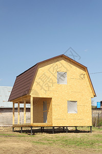 弗拉基米尔由木质板组成的小型郊区房屋在俄罗斯桑尼春日建造的堆地基上用曼沙来遮阳夹板乡村的图片