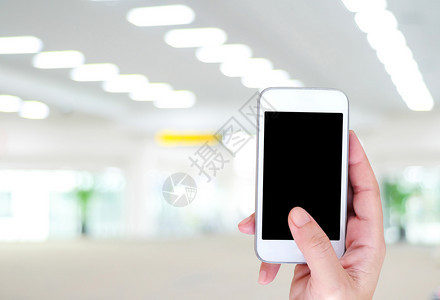 人们商业移动的手持智能电话机场背景模糊票在线概念旅行运输等机架有智能电话图片