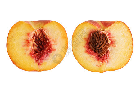 油桃健康将新鲜子切成两半白上分离种子生的图片
