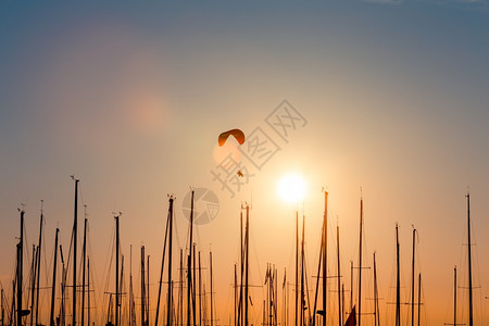 空气日落在游艇双轮和太阳海上滑翔降落伞图片