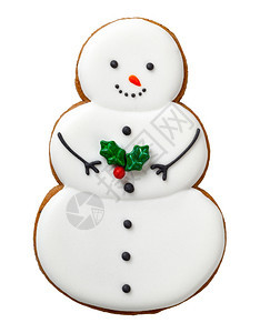 金子帽圣诞姜饼干在白色背景的雪人形状曲奇中被孤立甜的图片