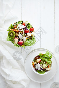 绿色不同的美味水果沙拉和白桌上不同水果健康食品概念在白色桌子上开胃图片